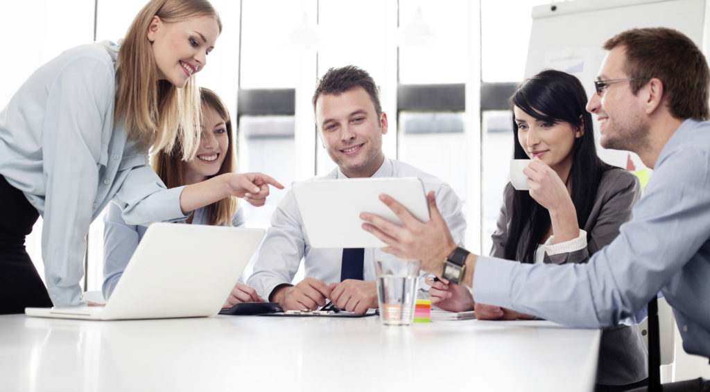 Five people working at conference table