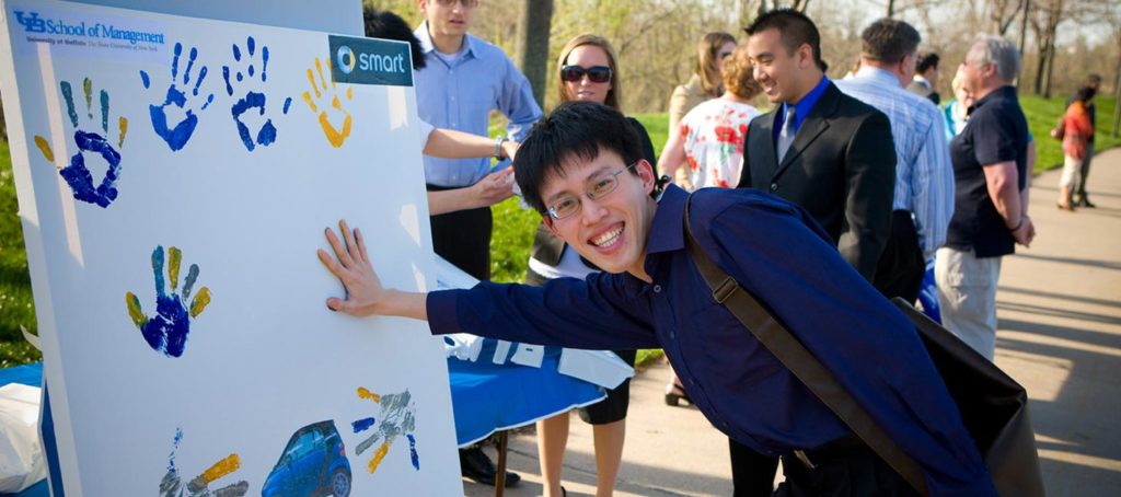MBA students making handprints
