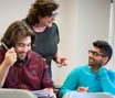 Student talking to professor in class