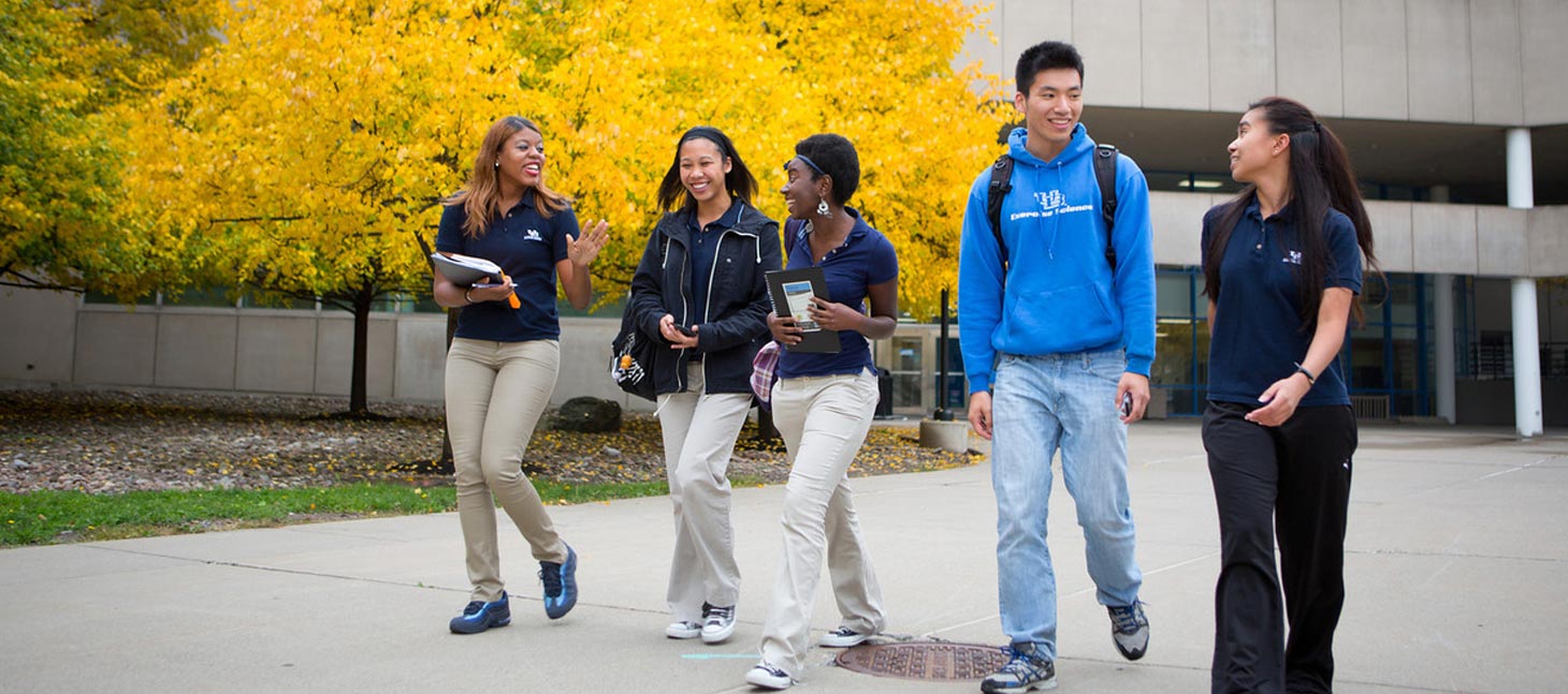 Students walking outside in the fall