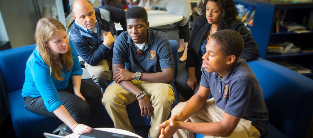 Graduate students meeting with a professor