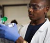 Student in lab with blue gloves