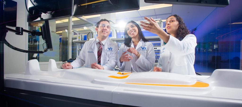 Medical students by a patient table