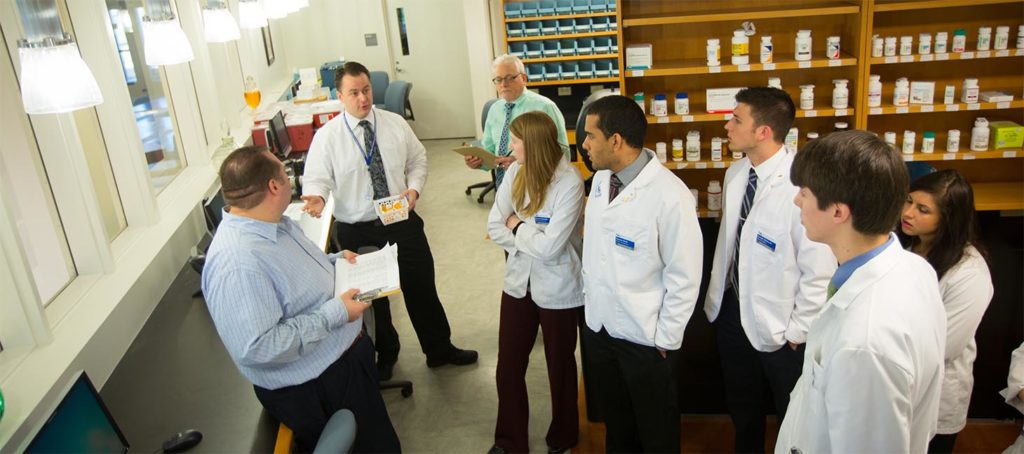 Pharmacy students listenting to faculty.