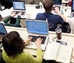 Students taking lecture notes on a computer