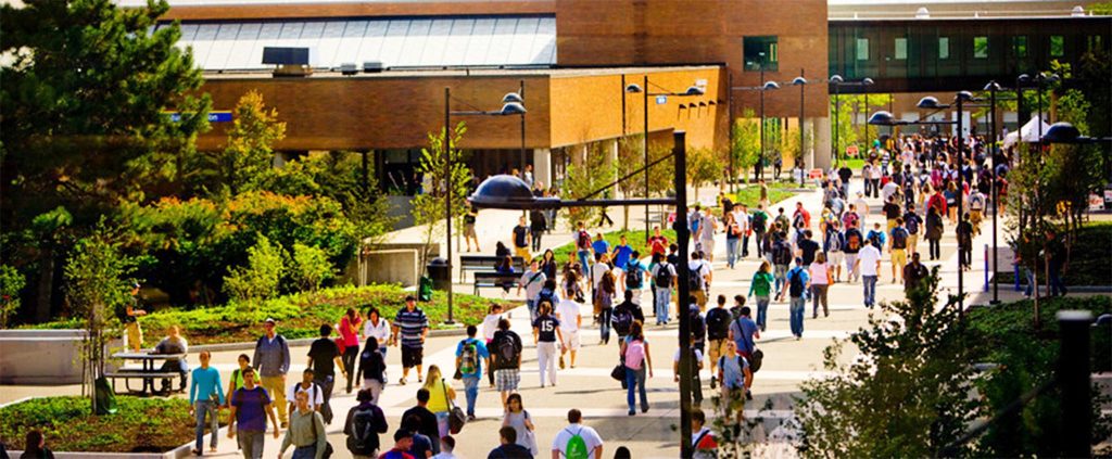 Students walking on Founder's Plaza on a sunny day.
